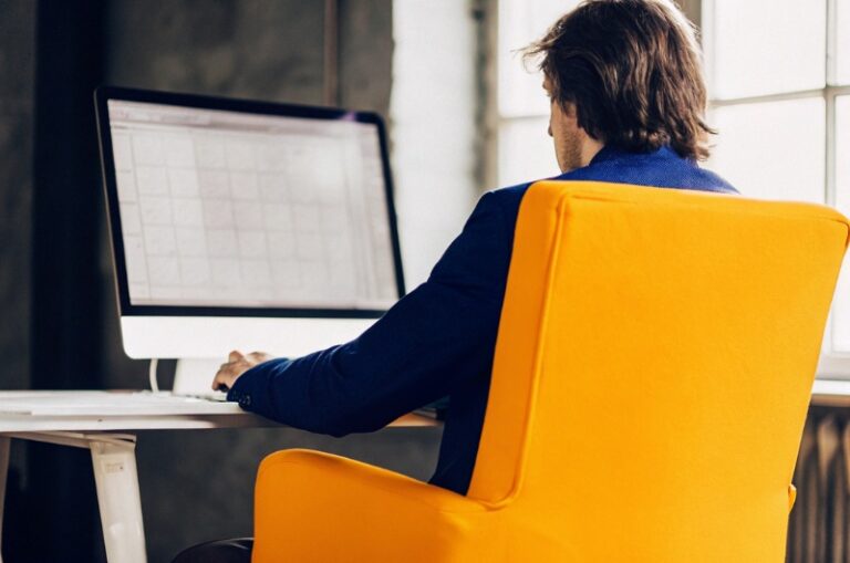 A clean and modern image depicting a person working on a computer.