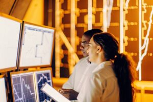 A TWO DOTS expert analyses big data on screens, with graphs