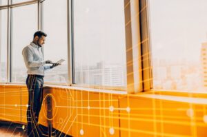 Entrepreneur looks at SEO reporting with advanced artificial intelligence in office