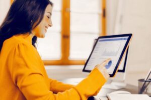 Female digital marketer designs social media campaign with modern tools