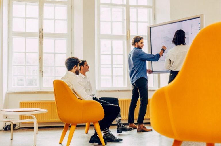 Modern team in a workshop with TWO DOTS UX Product Designer, discussing alternative career paths and job opportunities for the role of UX Product Designer