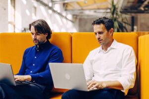 Two professionals compare ChatGPT and Google Gemini on TWO DOTS, analyzing the advantages of each AI platform for productivity.