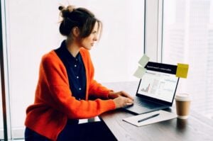 TWO DOTS team doing Content Optimization with keyword analysis on a laptop in a modern office